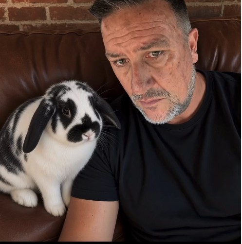 Joe Miller with a black-and-white rabbit